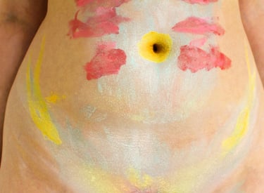A digital photography artwork featuring a stomach with makeup applied to it