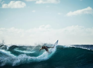 a person surfing on a big wave in the ocean