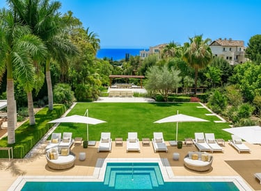 Villa Serenity pool terrace with sunbeds, umbrellas, and sea views