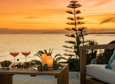 Sunset terrace with cocktails and candles overlooking the coastline