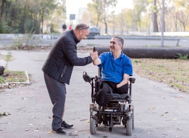 a man in a wheelchair is giving a fist bump