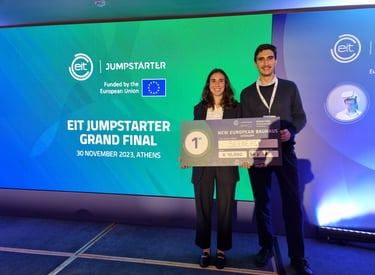 a man and woman standing next to a giant screen