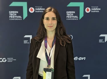 a woman in a suit and a name tag on a blue background