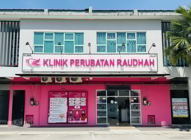 Exterior of Klinik Perubatan Raudah medical clinic featuring a pink storefront and signage.