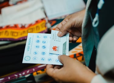 a person holding a piece of paper with a business card
