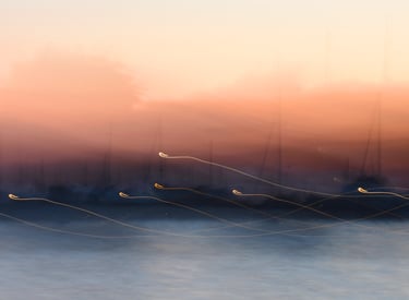 Intentional camera movement: pale blue and blush night in the harbour.