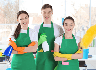 a group of people in green aprons and green aprons