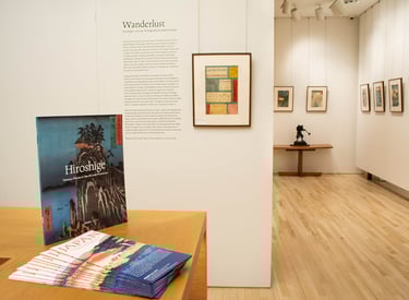 Installation photo of the exhibition Wanderlust that shows wall text and prints by Hiroshige