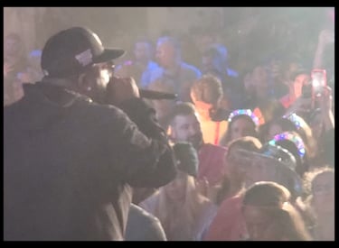 Hip hop artist entertains the crowd at an outdoor event. Planned, managed, and executed by Comprehensive Creations team.