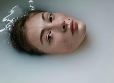 a woman in a bathtub, submerged with face showing