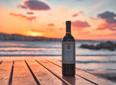 a bottle of greek red winefrom sclavos on a wooden table