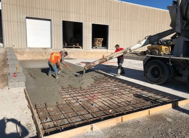 a man is pouring concrete into a concrete slab