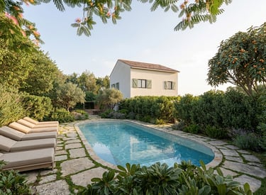 Luxury villa with a private swimming pool, sun loungers, and lush Mediterranean landscaping.