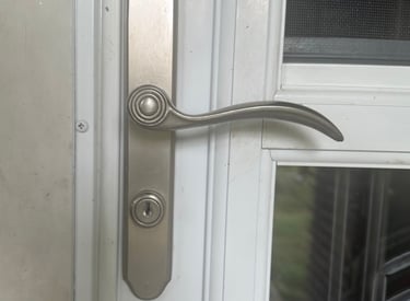 Residential door handle and lock on a white exterior door