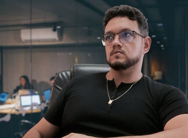 a man sitting at a desk with a laptop