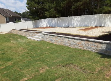 east west Clearing and excavation backyard patio with a raised deck and a raised deck