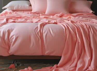 A variety of bed linens and blankets neatly arranged.