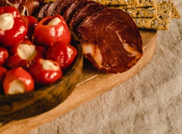 a wooden boarder with cheese and meats