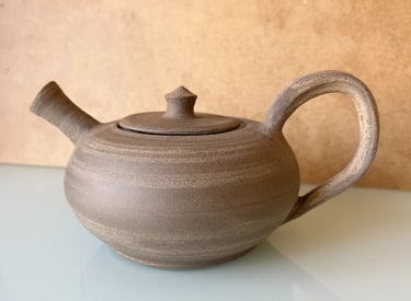 a teapot with a teapot on a table