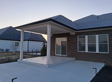 Patio before construction of three new walls with board and batten siding installation.