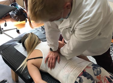 Dr. Lonna Denny performing the traditional spinal adjustment to a patient.