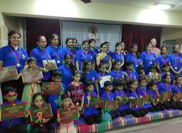 a group of people standing around a group of medals