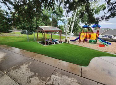 playground turf in a school with playground equipment