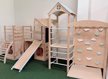 a play area with a wooden play structure