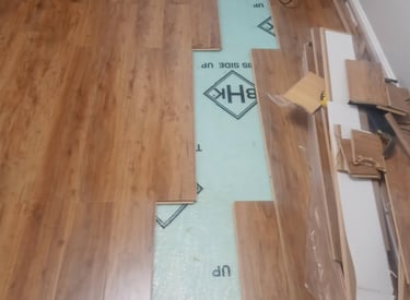 A room in the process of installing hardwood flooring.