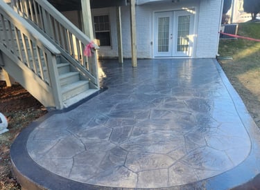 A deck with outdoor furniture and a patio area.