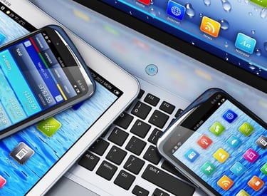 a laptop computer and a cell phone on a desk