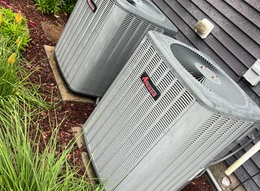 two hvac units sitting outside