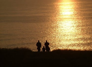Walkers silhouetted strolling down to the pub