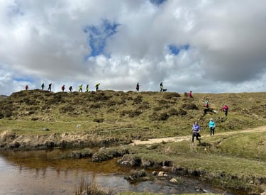 A group of runners running along a skyline