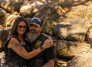 a man and woman sitting on a rock formation