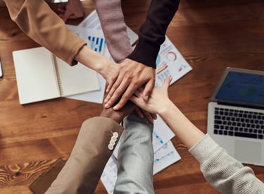 a group of people holding hands in a circle