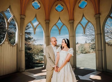 Couple holding hands inside an ornate pavilion in Park, captured by Fred Art Studio.