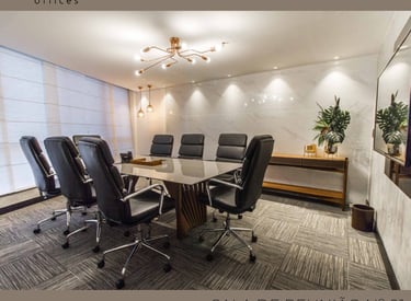 uma sala de conferências com mesa e cadeiras de conferência