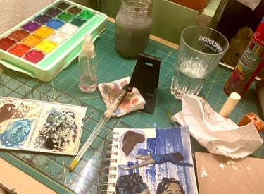 Picture of Takara's paints, paint brush and a canvas on which she is painting "It Almost Worked".  