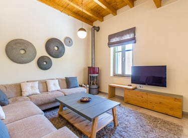 Spacious living room with modern decor and corner sofa at Villa Skyphos in Crete