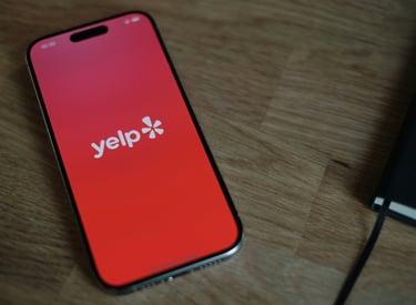 a picture of a cell phone with the Yelp app.  