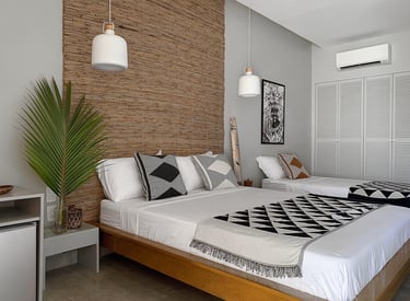 Deluxe Family Room: a bedroom with one bed for two person and one bed for one person
