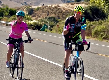 A man and a women cycling outside