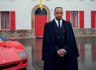Lewis Hamilton in a suit and coat with his Ferrari.