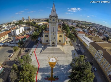 Vista aérea da Igreja Matriz de São Domingos em Araxá, destacando sua arquitetura e a praça ao redor