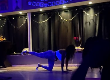 a woman doing a pilates pose on a yoga mat in a class