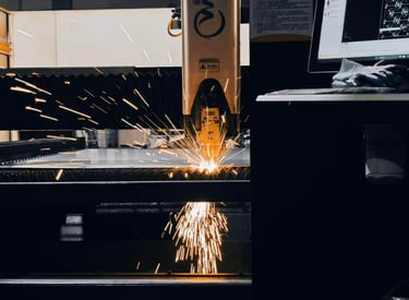 Sparks fly as laser cutting is in operation.