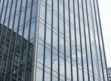Modern commercial building with sleek glass facade reflecting the sky