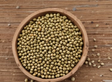 Close-up of vibrant cardamom pods spilling from a rustic burlap sack onto a wooden table.