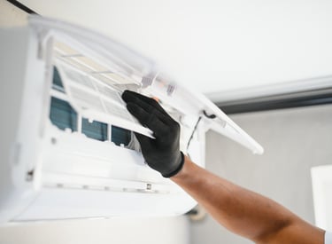 a man in gloves and gloves is holding a remote control unit